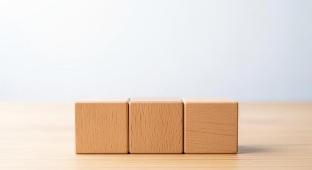 Three wooden toy blocks on a wooden table, great for text overlay and customizable messaging photo