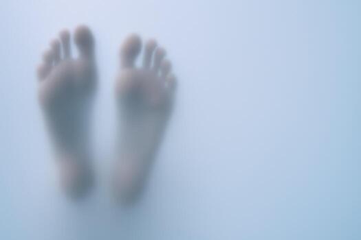 Bare Feet Behind Frosted Glass Conceptual Image for Privacy, Introspection, and Mystery photo