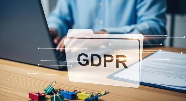 GDPR Compliance Concept Man Typing on Laptop with Data Protection Folder Overlay on Desk photo