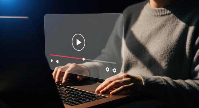 Person using laptop with player overlay, online streaming concept for entertainment and education photo