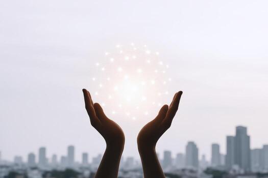 Hands Holding Glowing Sphere with Cityscape Background Power, Innovation, Technology Concept photo