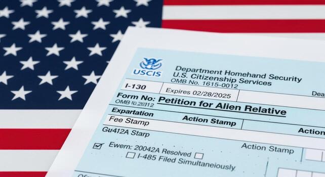 I-130 Petition for Alien Relative form in front of an American flag, symbolizing US immigration process photo