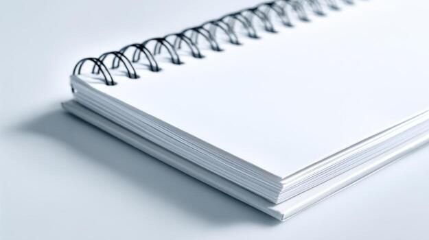 Blank Spiral Notebook with White Paper Pages for Writing or Sketching on a Neutral Surface photo