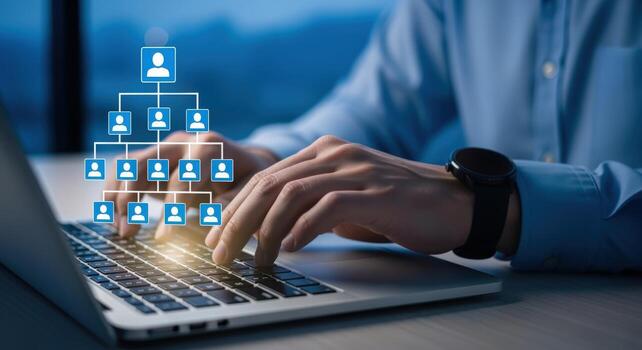 Man Typing on Laptop with Virtual Organizational Chart Overlay for Business Efficiency photo