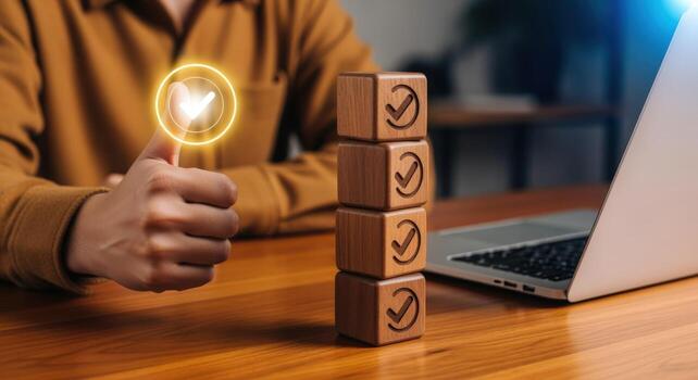 Business Approval with Wooden Blocks and Laptop, Hand Showing Thumbs Up Symbolizing agreement, confirmation, and checklist completion photo