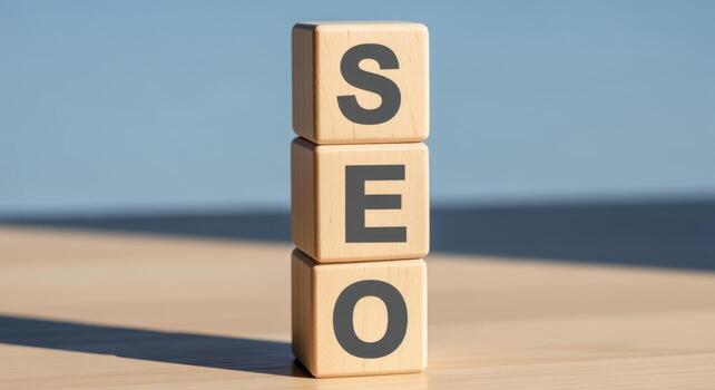 Stack of Wooden Blocks Spelling SEO on Tabletop Against Blue Background photo