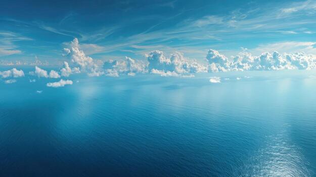 Vibrant Ocean View with Cumulus Clouds and Azure Waters Reflecting Sunlight, High Angle Shot photo