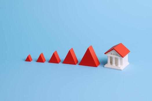 Financial Growth and Stability Abstract Bank Icon with Increasing Red Pyramids on a Blue Background photo