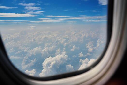 View on clouds through airplane window photo