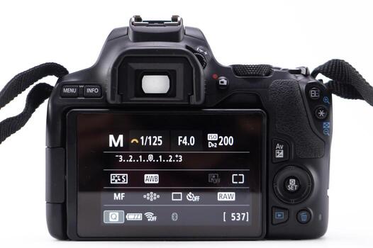 Back View of a Black Digital SLR Camera Displaying Settings on a White Background. photo