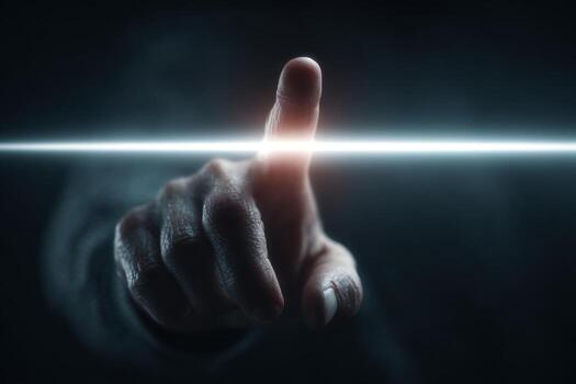 A person pointing at a light on a dark background photo