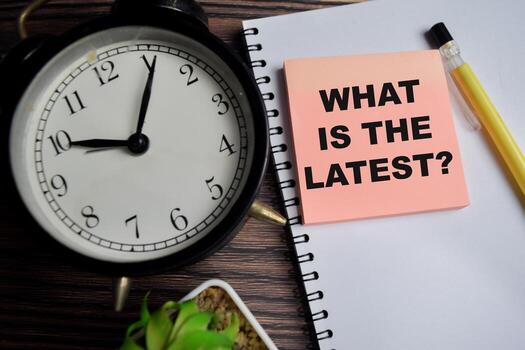 Concept of What is the latest write on sticky notes isolated on Wooden Table. photo