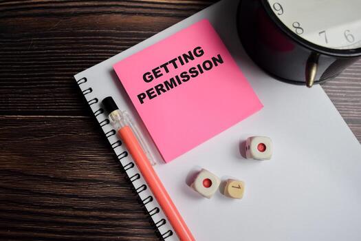 Concept of Getting permission write on sticky notes isolated on Wooden Table. photo