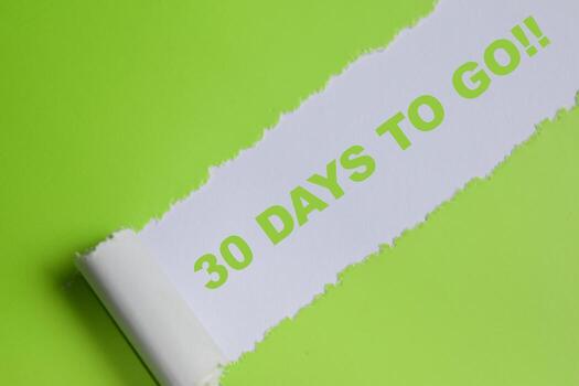 30 Days to go Text written in torn paper photo