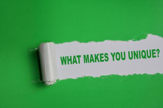 What makes you unique Text written in torn paper photo