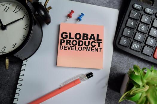 Concept of Global product development write on sticky notes isolated on Wooden Table. photo