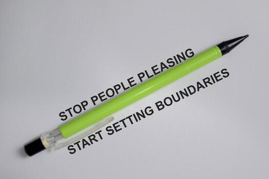 Concept of stop people pleasing and start setting boundaries with pen write on book isolated on Wooden Table. photo