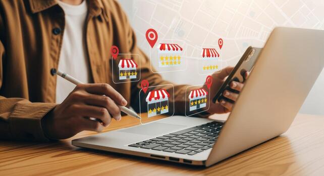 Man Using Laptop and Smartphone to Manage Multiple Store Locations Online for Business Growth photo