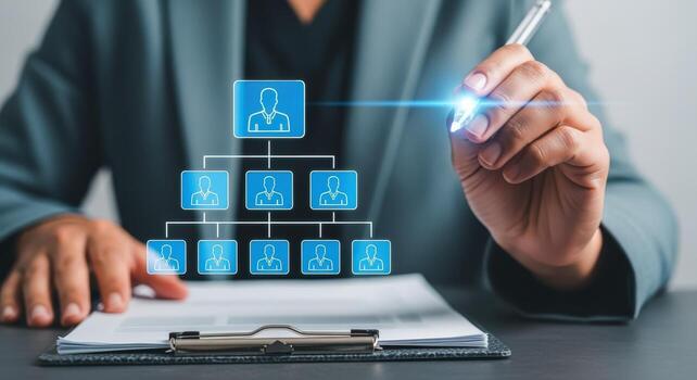 Business professional drawing company organizational chart, representing hierarchy, management structure, team and reporting relationships on digital display photo
