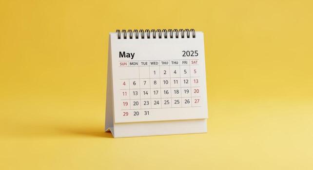 May 2025 Calendar Desk Stand Isolated on Yellow Background, Time Management and Planning Concept, Appointment and Schedule Reminder photo