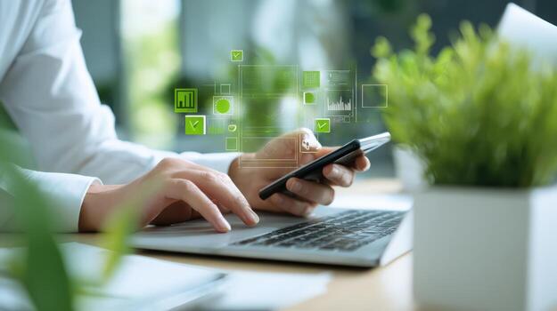 Person Analyzing Data on Laptop and Mobile Device with Abstract Green Visualizations Overlay photo