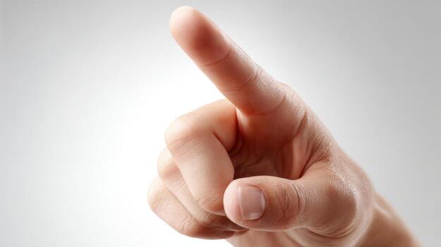 Human hand pointing upwards with index finger, representing direction, selection, choosing or attention on white background photo