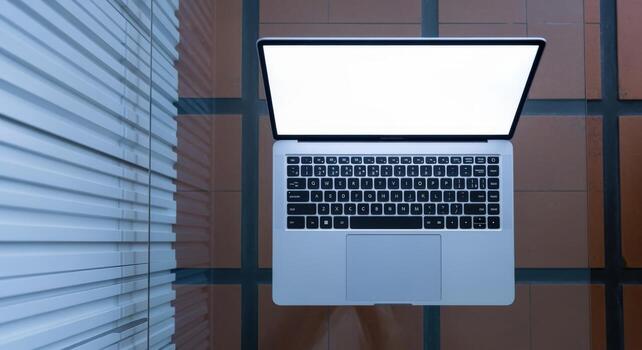 Laptop on Table Top-View of Modern Computer with Blank Screen for Business, Technology, and Design Mockups photo