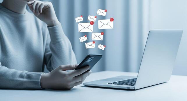 Woman Checks Smartphone for Email Notifications, Alongside Laptop, Representing Digital Communication and Online Messaging photo