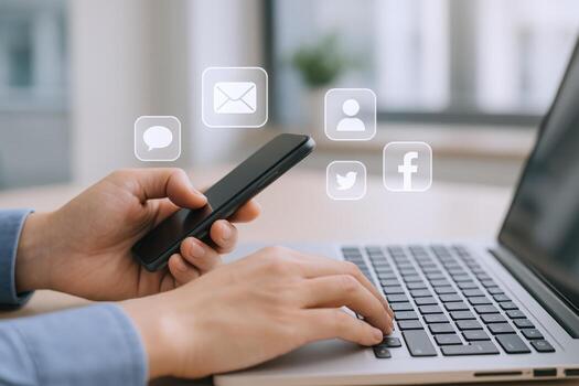 Hands Using Laptop and Phone with Social Media Icons Overlayed, Illustrating Connection and Communication photo