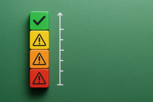 Risk Assessment Colorful Blocks Stacked with Checkmark, Warning Signs, and Ascending Arrow on Green Background photo