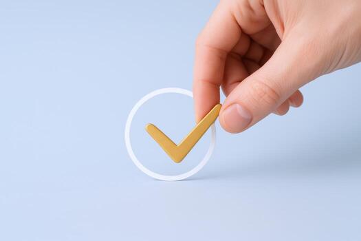 Hand Placing Gold Check Mark Inside White Circle on Blue Background Symbolizing Approval photo