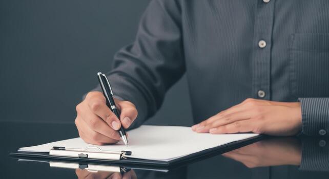 Signing Documents Close-Up of Hand with Pen Writing on Paper, Business Concept, Neutral Background photo
