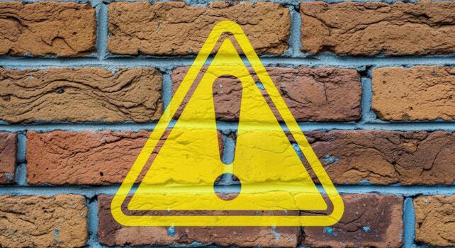 Warning Sign on Brick Wall, Caution and Alert Message with Exclamation Mark, Hazard Indication photo