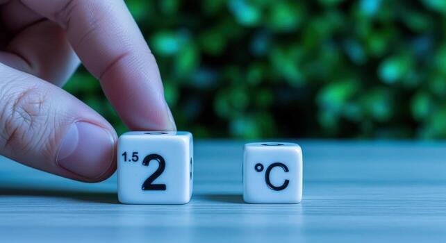 Limiting Global Warming Concept Depicting 2 Degrees Celsius Target with Hand and Blocks on Textured Surface photo