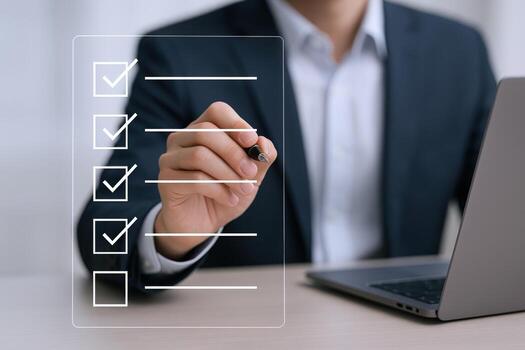 Professional Man Completing Checklist on Transparent Screen with Laptop in Office Setting for Business Task photo