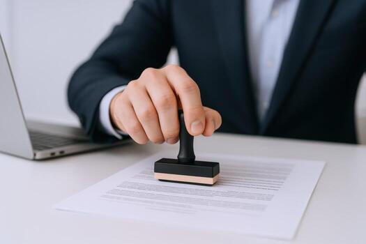 Close-up of a Mans Hand Using a Stamp on a Document, Legal Approval and Certification photo