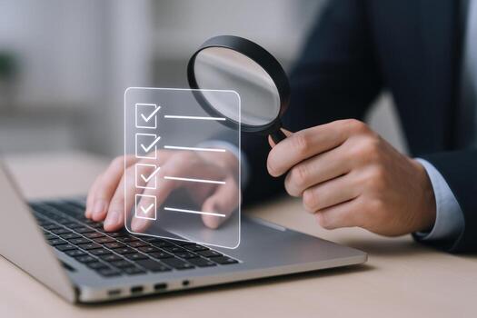 Digital Checklist Inspection Businessman Verifying Online Form with Magnifying Glass on Laptop, Business Concept photo
