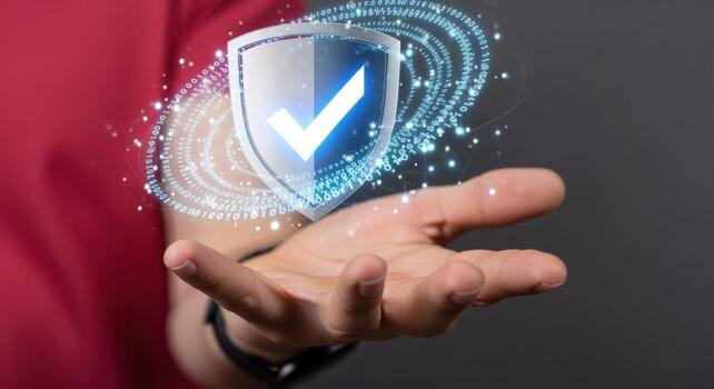 Hand presents digital shield with checkmark, representing cybersecurity, data protection, and reliable technology in a modern design photo