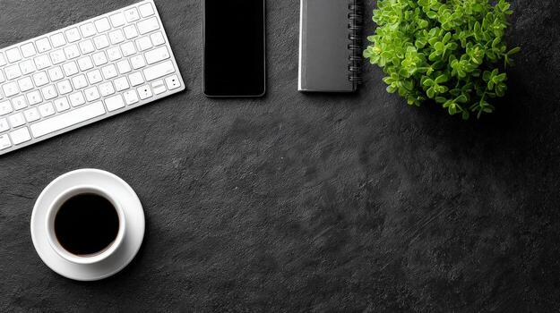 Workspace essentials on dark stone background, top view of keyboard, coffee, phone, and notebook photo