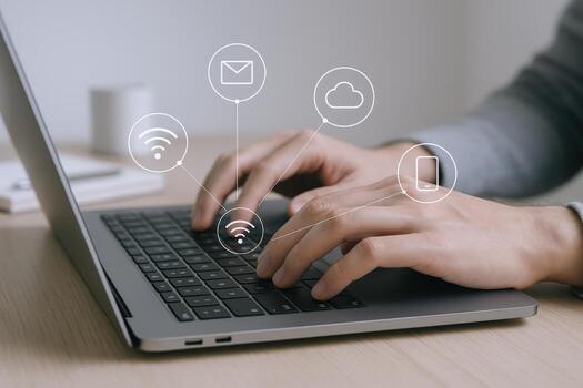 Hands Typing on Laptop with Cloud, Email, Smartphone, and Wifi Icons Overlayed for Business photo