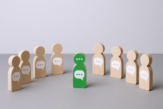 Conceptual Wooden Figures Illustrating Communication, Influence and Leadership in a Group Setting, Depicting Social Networking and Community photo