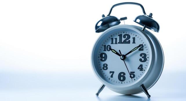 Classic Twin Bell Alarm Clock Showing Time, Time Management and Punctuality, Isolated on White Background photo