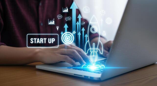 Entrepreneur Using Laptop with Startup Concept Hologram Projecting, Symbolizing Business Launch and Growth Trajectory photo