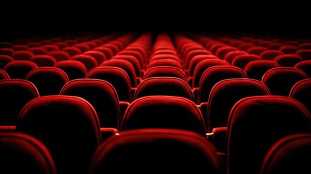 Rows of Empty Red Seats in a Theater or Cinema, Dramatic Perspective and Dim Lighting photo