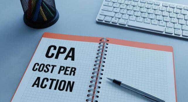 Cost Per Action Business Concept Displayed on a Notebook with Keyboard and Pen, Illustrating Digital Marketing photo