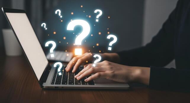 Typing on Laptop Surrounded by Question Marks Seeking Answers, Solutions, and Information Online photo