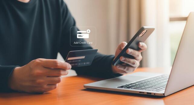 Online Shopping Man Holds Credit Card and Uses Phone for Secure Digital Payment photo