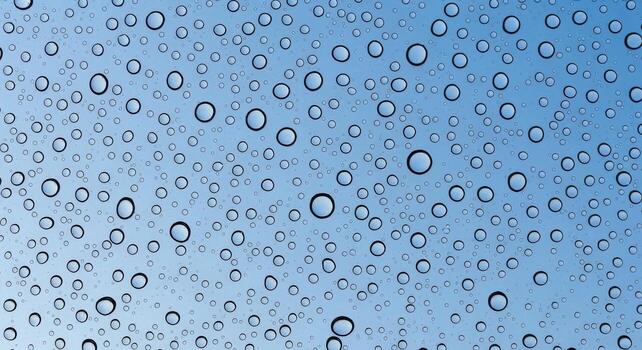 Raindrops on a Glass Surface with Sky Reflections, Abstract Background for Weather Concepts photo