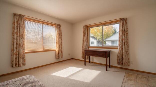 Bright Empty Room with Natural Light, Two Windows and a Table in Residential Home photo