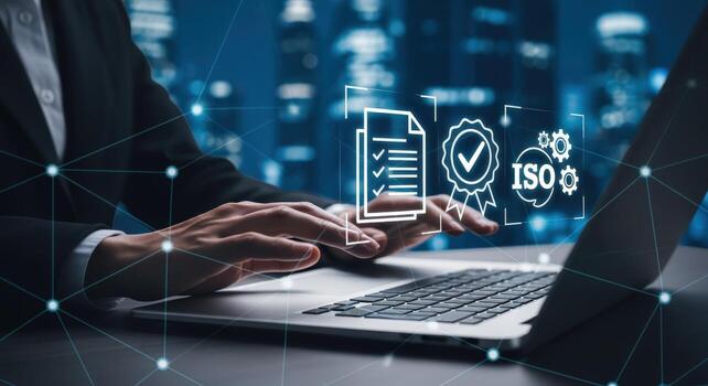 Professional using laptop for quality control, compliance and ISO certification with virtual graphic in a modern office photo